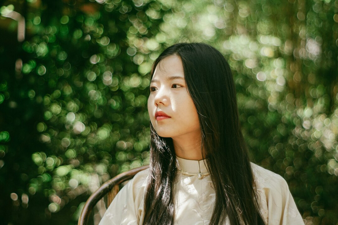 Portrait of a Chinese-Malaysian woman with glasses, friendly expression