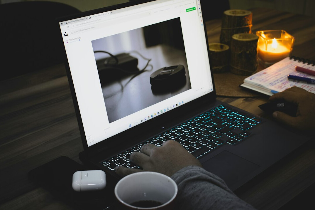 person coding on laptop