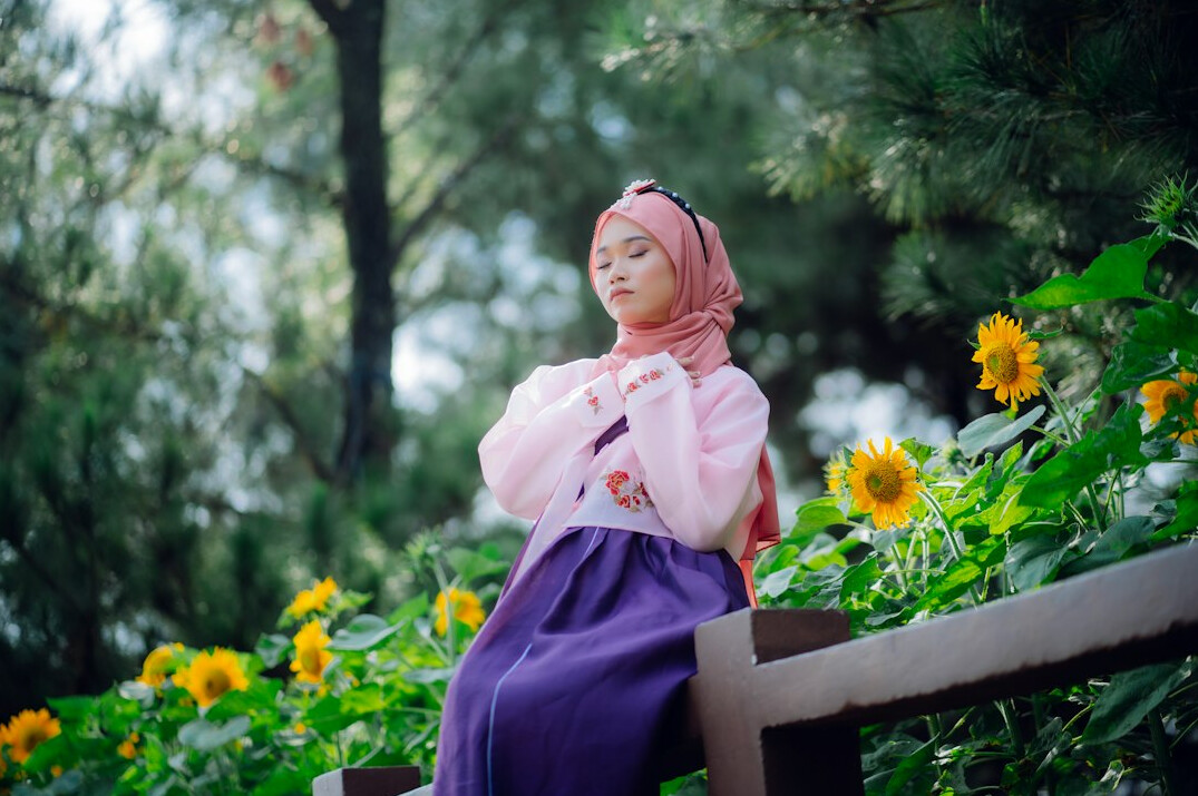 Portrait of a young Malay woman smiling, wearing a hijab