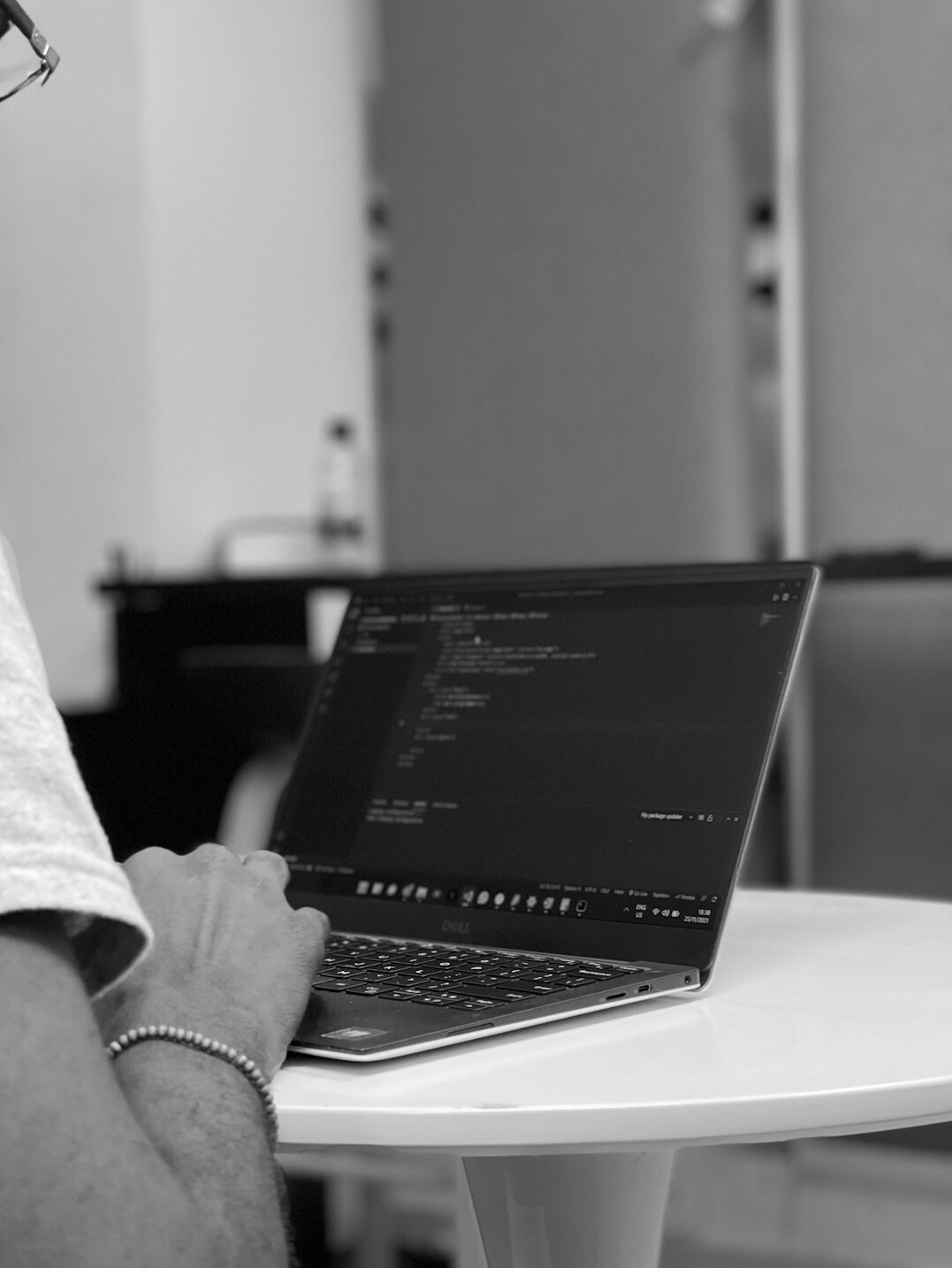 programmer coding on laptop in office
