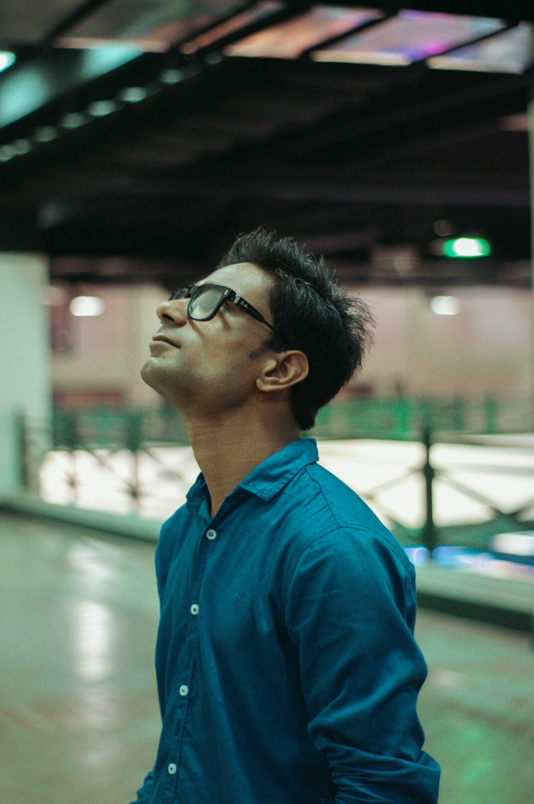 Portrait of a Malaysian Chinese man in his thirties wearing glasses and a casual shirt