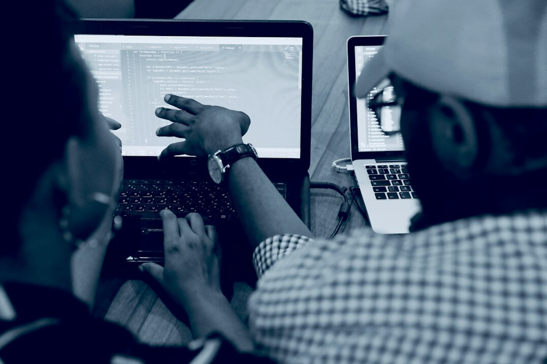 group of diverse students coding together
